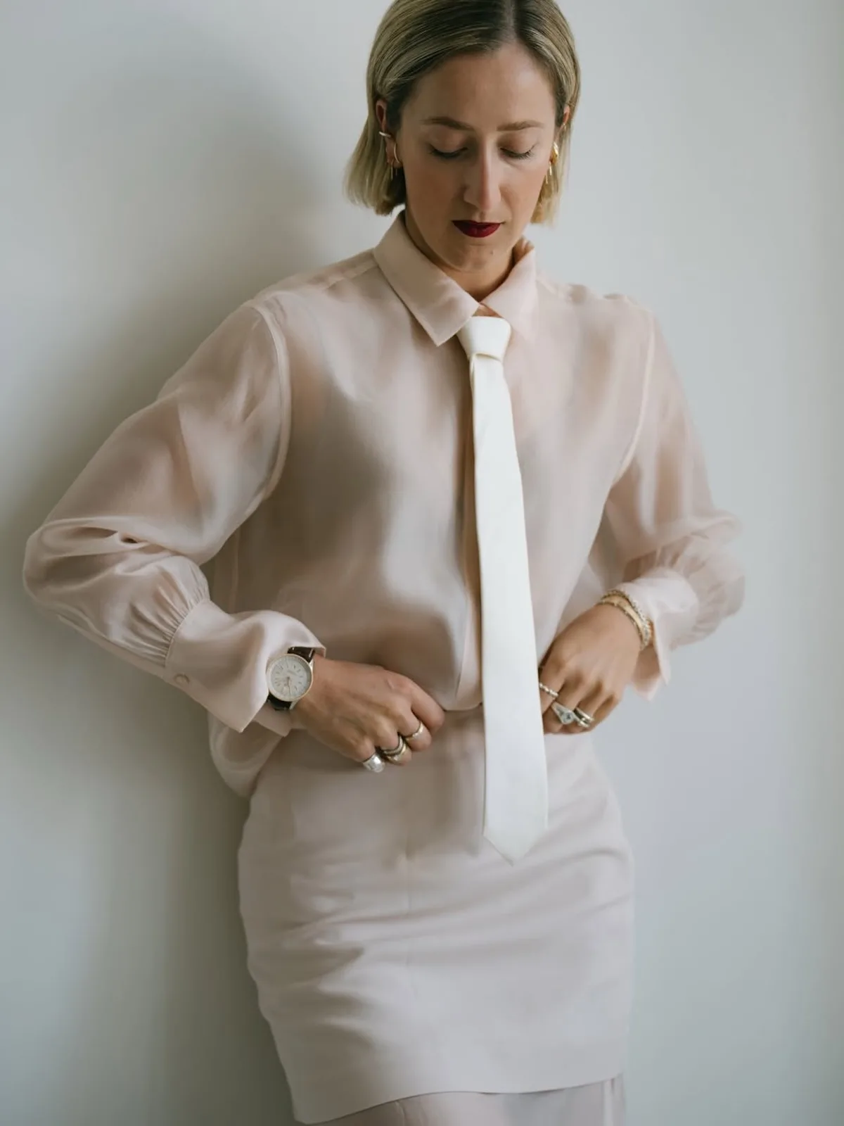 Modelka w eleganckiej jasnej stylizacji pozuje w sesji modowej Peek &amp; Cloppenburg. Zdjęcie ilustruje zagadnienie ofert promocyjnych w Peek &amp; Cloppenburg, obniżek cen i oskarżeń UOKiK w stosunku do firm odzieżowych.