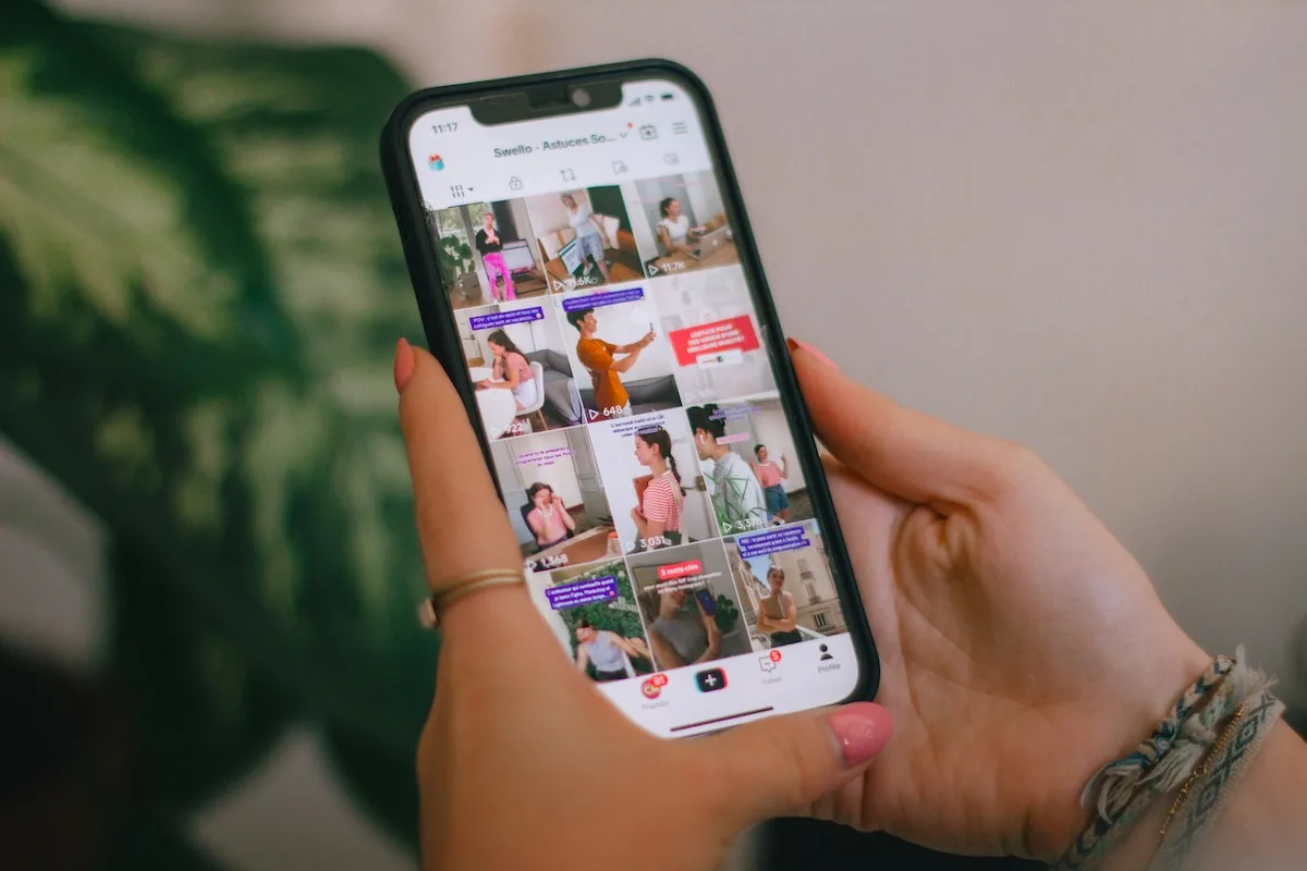 Użytkowniczka przegląda TikToka na smartfonie. TikTok Shop umożliwi nabywanie produktów podczas oglądania nagrań i treści influencerów.